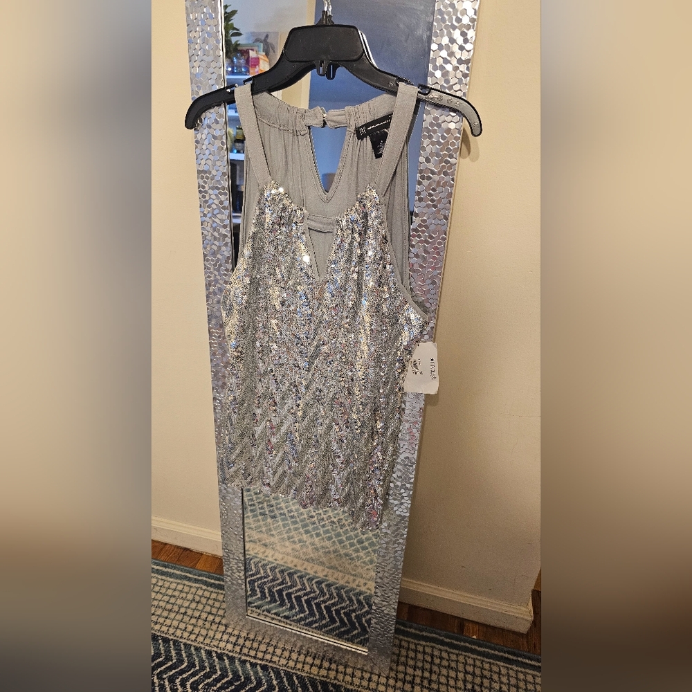 Party top size large- shinny silver. INC